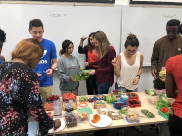 People gathered around a table with healthy food options